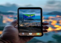 A realistic photo of an iPhone screen showing a prompt to download an app from a website outside the App Store, with a Brazilian flag in the background and a blurred cityscape of Rio de Janeiro.