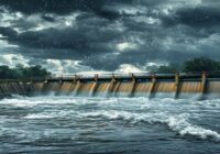 A realistic photo of an irrigation dam with overflowing water during a heavy rainstorm, showing safety structures like spillways and warning signs, dramatic sky with dark clouds, water splashing, phot