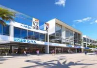 Photorealistic wide shot of the Palau Municipal d'Esports in Badalona, Spain, exterior view with modern architecture, clear blue sky, banners of ACB Supercopa hanging from the facade, people entering