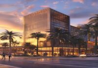 Photorealistic image of the JW Marriott Hotel Lima exterior at sunset, with modern architecture and palm trees, luxurious entrance, people walking, clear sky, warm lighting.
