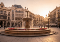 Realistic photo of Plaza de los Luceros in Alicante during golden hour, with the central fountain and people walking, modernista buildings in background, vibrant colors, no text.