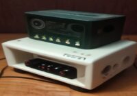 A DIY portable granular synthesizer with Raspberry Pi Pico, OLED screen, knobs, and 3D printed case on a table, realistic photo