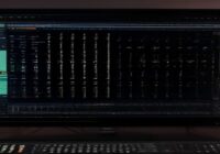 Photorealistic close-up of a modular synthesizer interface displayed on a computer screen, with colorful patch cables connecting modules, knobs and sliders, in a home studio environment.
